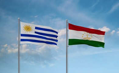 Tajikistan and Uruguay flags, country relationship concept