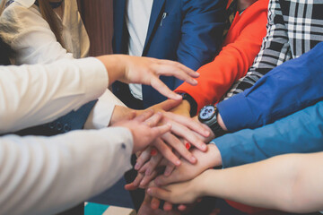 Group team of young people stacking hands together during contest competition, corporate business...