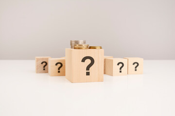 question mark concept. wooden cube with question mark symbol on grey background.