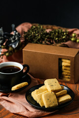 Crunchy cookies biscuits served in plate with black coffee isolated on table side view of american cafe baked food