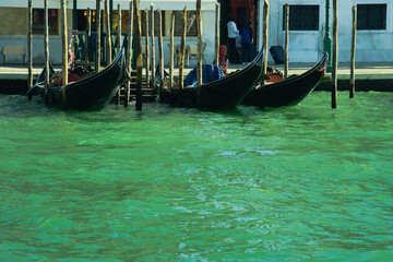 Fototapeta na wymiar Gondolas moored in the Venice lagoon. In the distance the island of San Giorgio Maggiore.