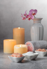 Obraz na płótnie Canvas Sea salt, towels, orchid flowers, and burning candles.