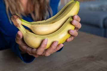 The woman holds food in her hand. the girl holds in her hands