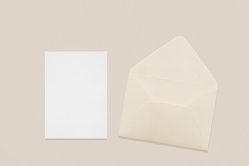 Wedding stationery invitation card mockup 5x7 and beige envelope on neutral beige background, bridal shower mockup. Minimal blank card mockup, thank you card, greeting card - obrazy, fototapety, plakaty