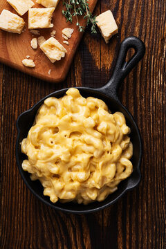 Homemade mac and cheese pasta  in cast iron pan ready to bake, top view