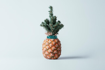 Christmas creative concept. Christmas pineapple with crown in the form of a Christmas tree on blue...