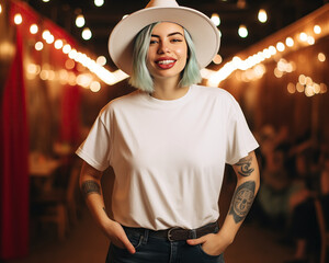 tshirt mock up cowgirl:: A curvy hipster alternative woman with tattoos, green hair wears a cowboy hat in a saloon bar. A blank white t shirt mockup. Disco cowgirl bachelorette aesthetic - obrazy, fototapety, plakaty