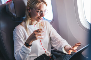 Caucasian young woman using wifi on board