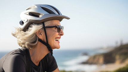 Caucasian 60 years old woman on a bicycle with helmet. Elderly people, sports and healthy live. Copy space.