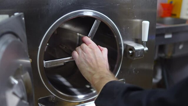 chef adjusting ice cream freezer machine, ice cream production. High quality 4k footage