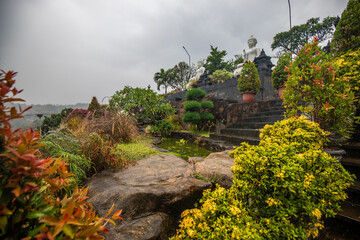A Buddhist temple in the evening in the rain. The Brahmavihara-Arama temple has beautiful gardens...