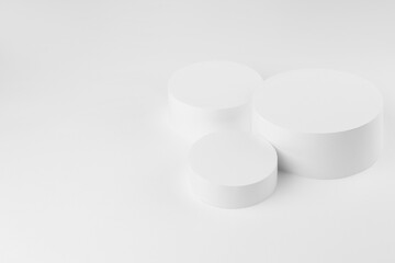 Abstract stage mockup with set of three round podiums for presentation cosmetic products, goods, advertising, design on white background. Abstract scene in soft light modern minimal style.
