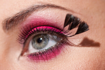 Naklejka premium Crop of female eye with colorful make up. Beautiful fashion model with creative art makeup