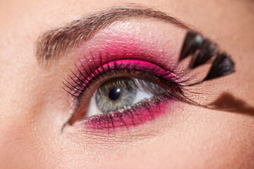 Obraz premium Crop of female eye with colorful make up. Beautiful fashion model with creative art makeup