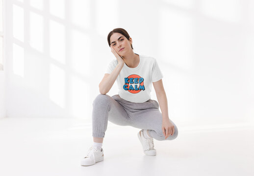Mockup of young woman wearing customizable t-shirt, crouching