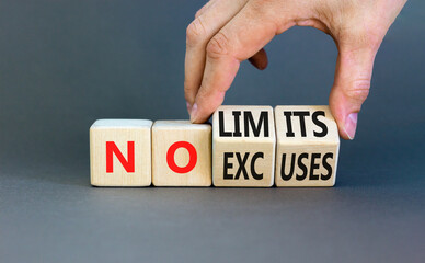 No excuses limits symbol. Concept words No excuses No limits on wooden block. Beautiful grey table grey background. Businessman hand. Business motivational no excuses limits concept. Copy space.