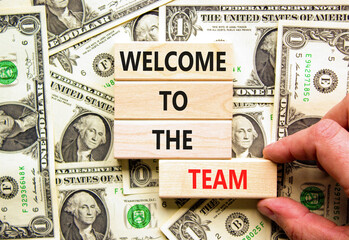 Welcome to the team symbol. Concept words Welcome to the team on wooden block. Dollar bills....