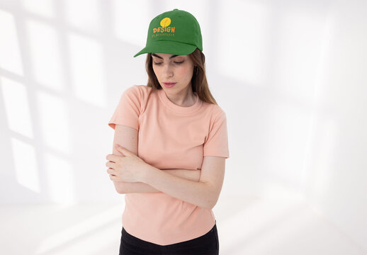 Mockup of young woman wearing customizable cap, arms folded