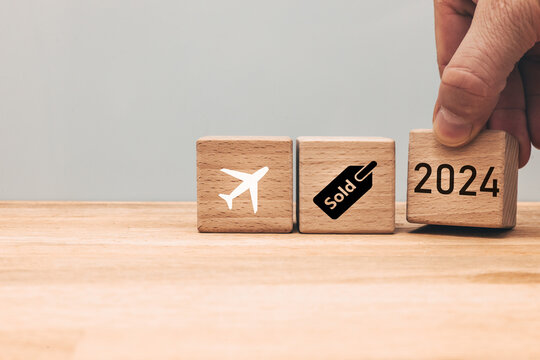 Aviation business 2024, Air ticket sales, Airline statistics, Concept, Wooden blocks with airplane, sales and year symbols