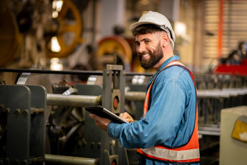 Young male engineer in metal sheet factory Responsible work is being inspected at the actual work site