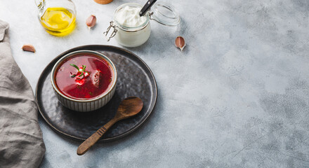 Traditional Ukrainian beet soup - borscht on the grey background, copy space for text