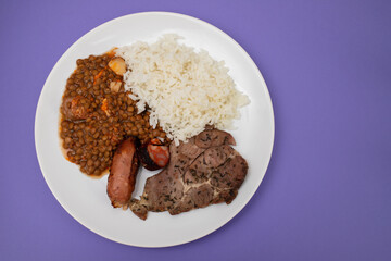 grilled meat, sausage, lentils and boiled rice
