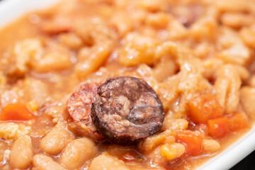 typical portuguese dish dobrada with beans in ceramic bowl