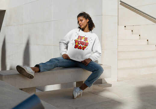 Mockup of woman wearing customizable sweatshirt on urban bench