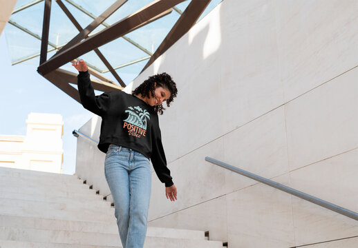 Mockup of woman wearing customizable sweatshirt on urban steps