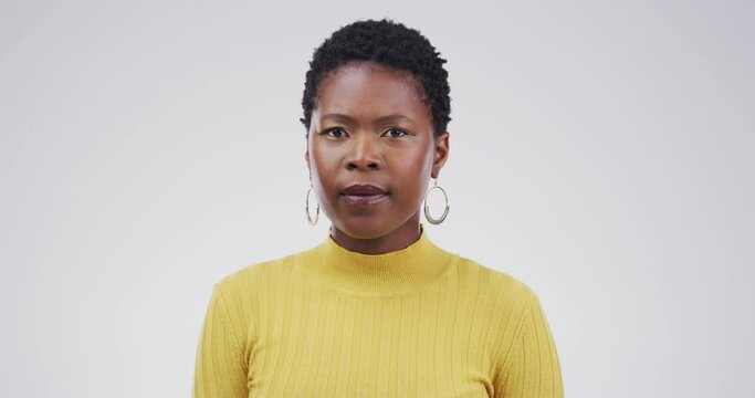 Black woman, face and blank stare standing in confidence isolated on a studio white background. Portrait of attractive African female person or casual model looking with no expression on mockup space