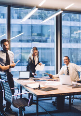 Businesswoman explaining company strategy to professional team of employees