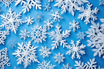 Fototapeta na wymiar Beautiful white paper cut out snowflakes on a blue background.
