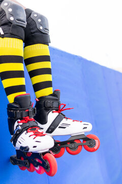 Woman Wearing Yellow Striped Socks And Roller Skate Shoes At Skate park
