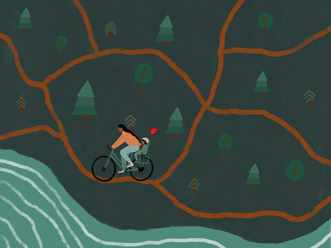 Man cycling with child and balloon in forest