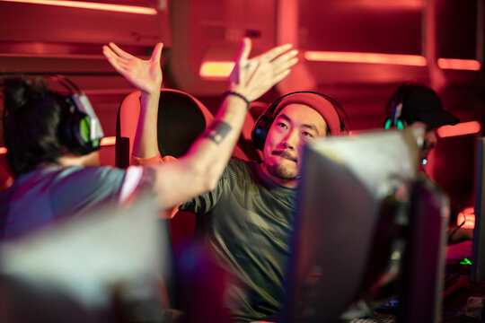 Esports player celebrates a victorious moment with teammates