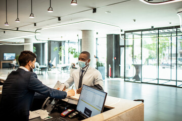 Businessman checking into a hotel at the reception