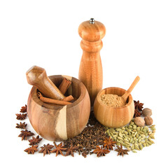 Mortar with pestle, hand mill and spices set isolated on white.