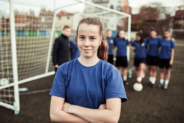 Portrait of a young female soccer player on the field