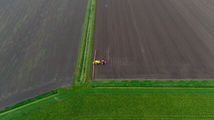 Tractor Spraying On Field With Sprayer, Herbicides And Pesticides