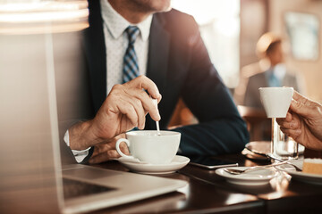 Close up of two businessmen drinking coffee in a cafe
