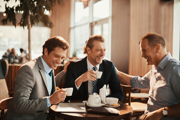 Three businessmen having coffee in a cafe
