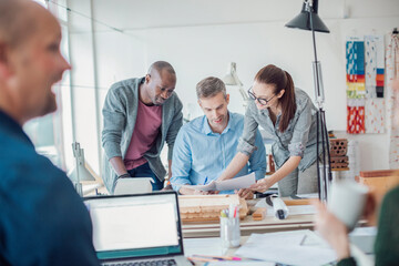 Diverse trio of designers working in a modern office