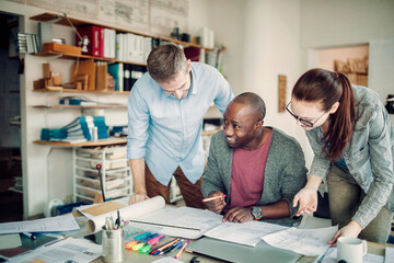 Diverse trio of designers working in a modern office