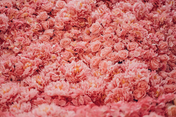 Floral background texture for ceremony or photo shoot. Artificial flowers in pastel colors on the...