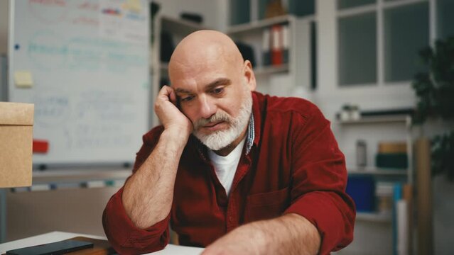 Portrait of overwhelmed small business owner working long hours, having problems