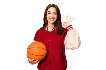 Young basketball player woman over isolated chroma key background showing ok sign with fingers