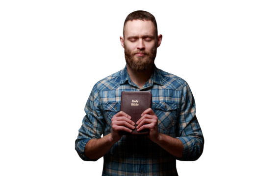 Handsone man reading and praying over Bible