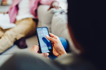 person holding smartphone checking updates notification spending time at apartment