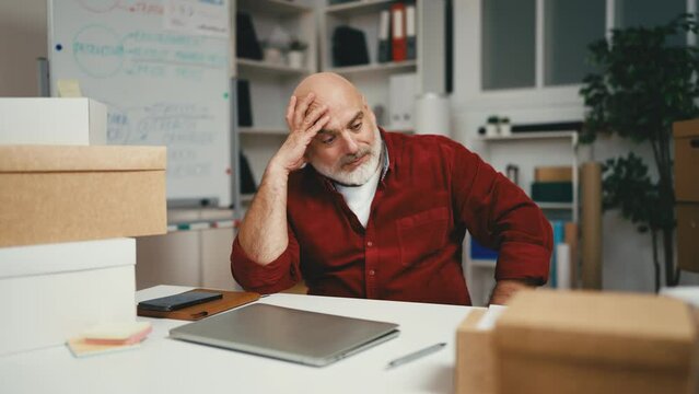 Man in his 40s feeling upset at work, lost business deal, decreasing income