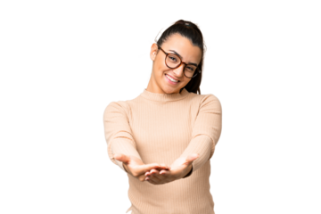 Young beauty woman over isolated chroma key background holding copyspace imaginary on the palm to insert an ad